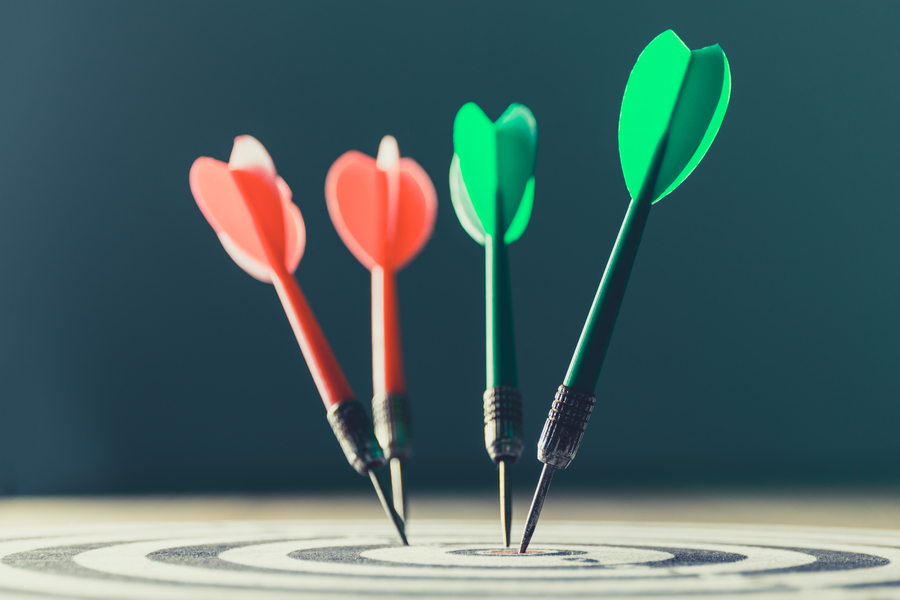 dart arrow hitting in the target center of dartboard,abstract of success